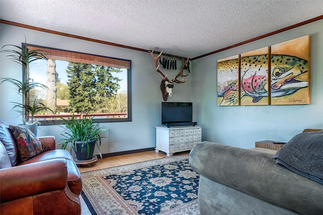 living room featuring hardwood / wood-style floors, a textured ceiling, and crown molding