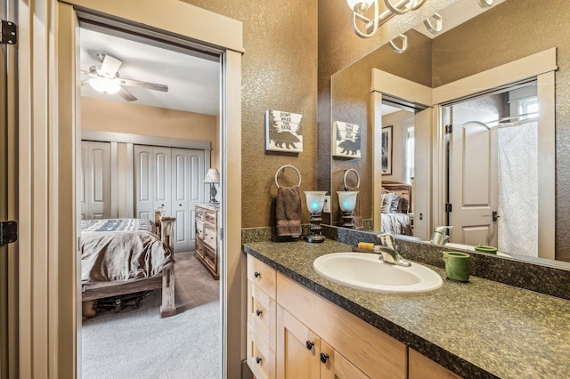 282 Mcwenneger Dr, Kalispell, MT 59901 - bathroom with ensuite bathroom, a textured wall, vanity, and ceiling fan