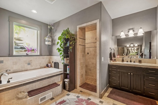 282 Mcwenneger Dr, Kalispell, MT 59901 - full bath featuring a garden tub, tiled shower, vanity, and tile patterned floors