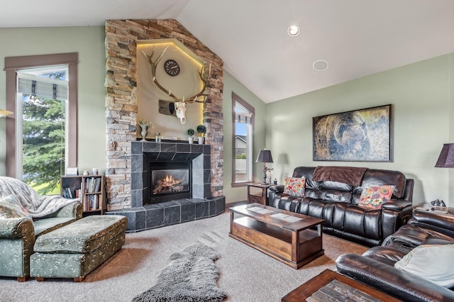 living room featuring a fireplace, carpet floors, and vaulted ceiling