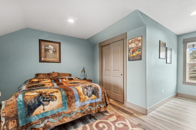 282 Mcwenneger Dr, Kalispell, MT 59901 - bedroom featuring light wood-style flooring, vaulted ceiling, a closet, and recessed lighting