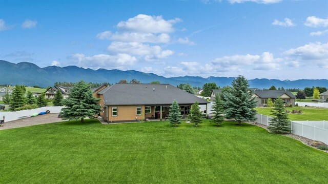282 Mcwenneger Dr, Kalispell, MT 59901 - rear view of house featuring a mountain view, a fenced backyard, and a patio