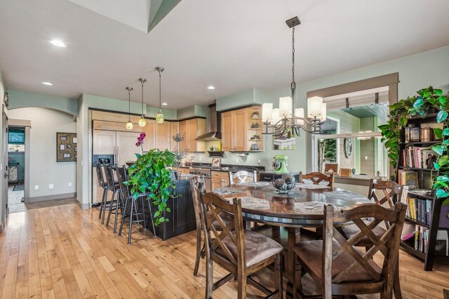 282 Mcwenneger Dr, Kalispell, MT 59901 - dining area featuring a chandelier, light wood-type flooring, arched walkways, and recessed lighting