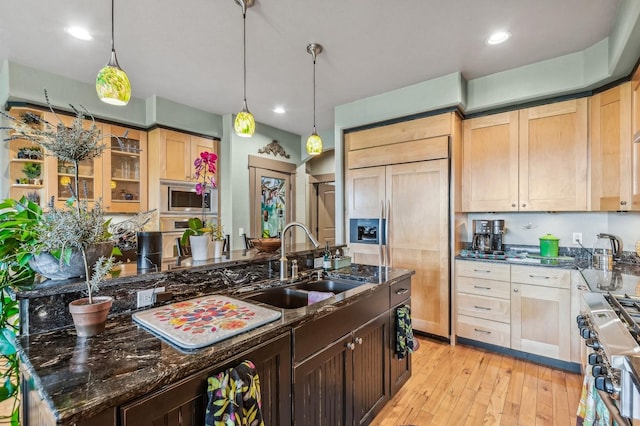 282 Mcwenneger Dr, Kalispell, MT 59901 - kitchen with built in appliances, light wood-style flooring, dark stone countertops, light brown cabinetry, and recessed lighting