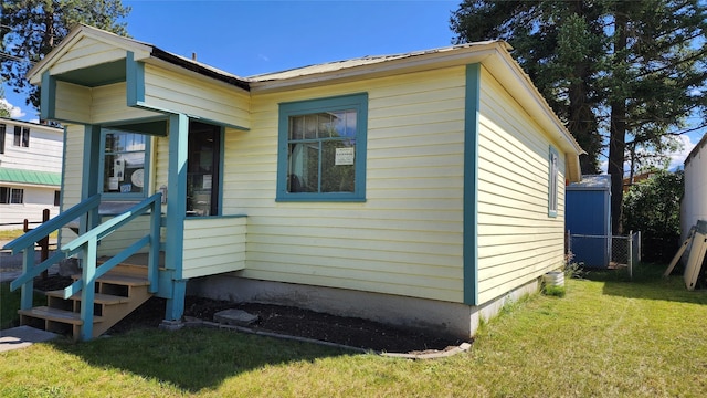 view of side of home with a yard