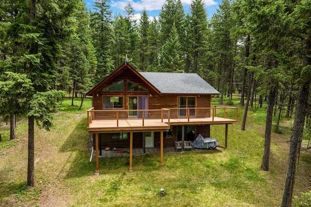 112 Glen View Dr, Eureka, MT 59917 - back of house with a lawn, a deck, and a forest view