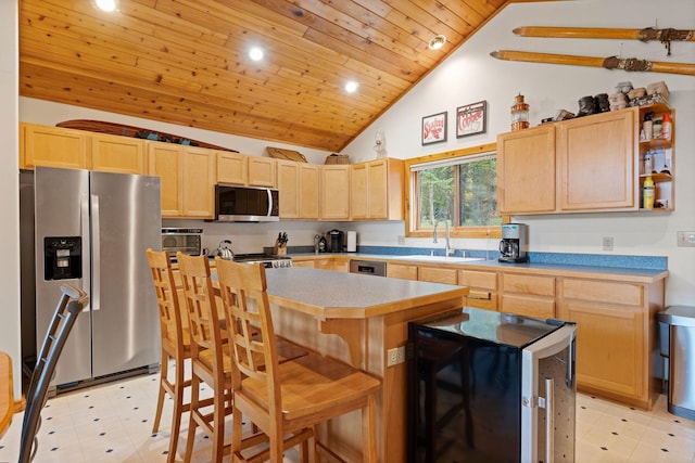 112 Glen View Dr, Eureka, MT 59917 - kitchen with light brown cabinetry, stainless steel appliances, light floors, wooden ceiling, and a kitchen island