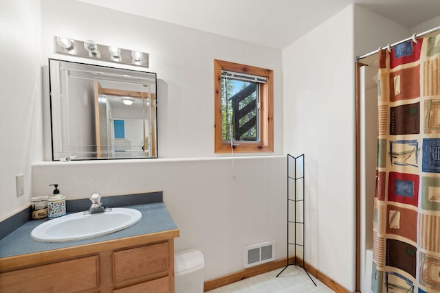 112 Glen View Dr, Eureka, MT 59917 - bathroom with toilet, vanity, visible vents, a shower with shower curtain, and baseboards