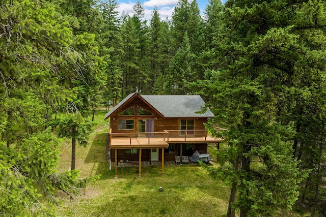 112 Glen View Dr, Eureka, MT 59917 - rear view of property with a yard, a wooden deck, and a wooded view