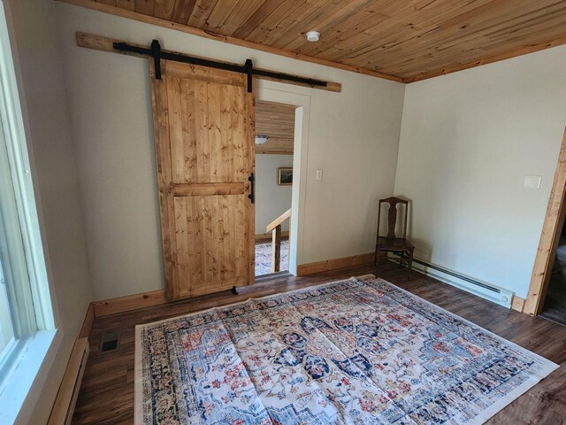 213 Washington St, Thompson Falls, MT 59873 - unfurnished room with a barn door, wood finished floors, a baseboard radiator, and visible vents