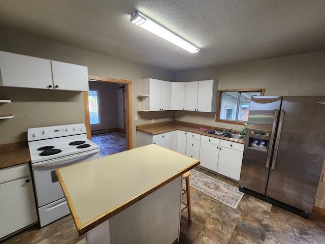 kitchen featuring dark tile patterned floors, white cabinets, white range with electric stovetop, a kitchen island, and stainless steel refrigerator with ice dispenser