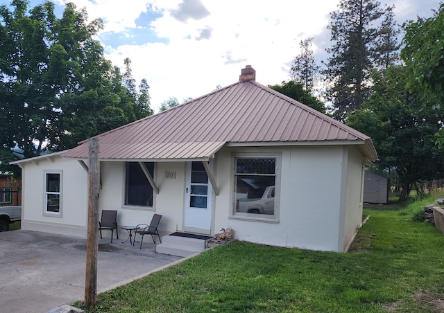 rear view of house featuring a patio and a yard