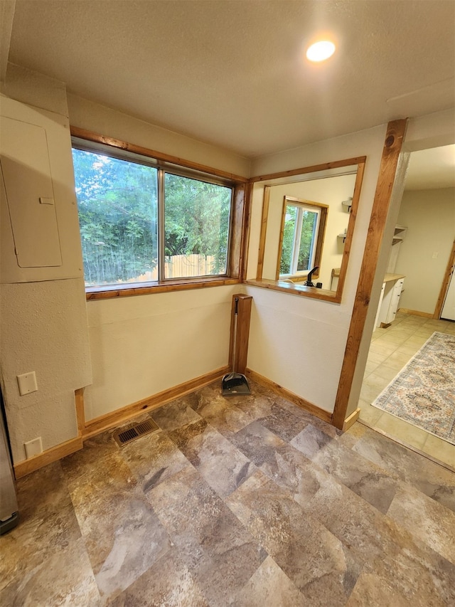 interior space featuring tile patterned floors and a textured ceiling