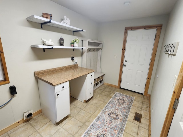 clothes washing area featuring light tile patterned flooring