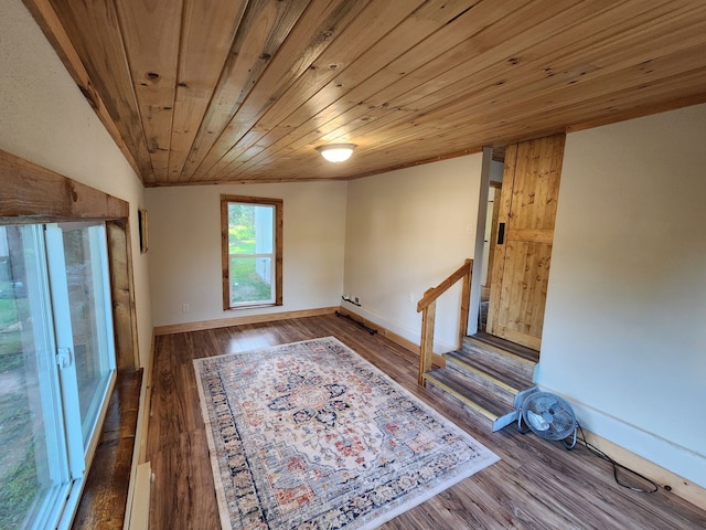 spare room featuring dark hardwood / wood-style floors, vaulted ceiling, wood ceiling, and a baseboard radiator