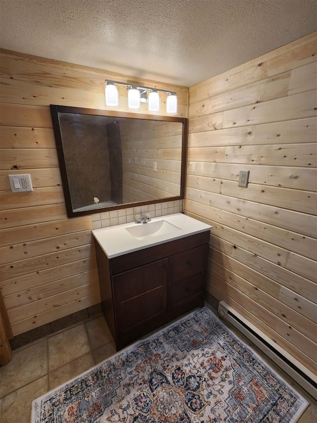 213 Washington St, Thompson Falls, MT 59873 - bathroom with wooden walls, vanity, and a textured ceiling