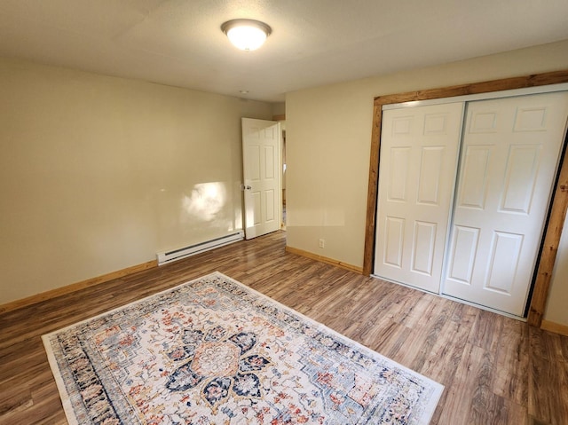 213 Washington St, Thompson Falls, MT 59873 - unfurnished bedroom with baseboards, baseboard heating, and wood finished floors