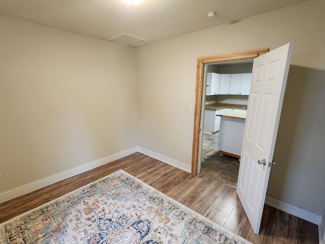213 Washington St, Thompson Falls, MT 59873 - unfurnished bedroom with attic access, baseboards, and wood finished floors