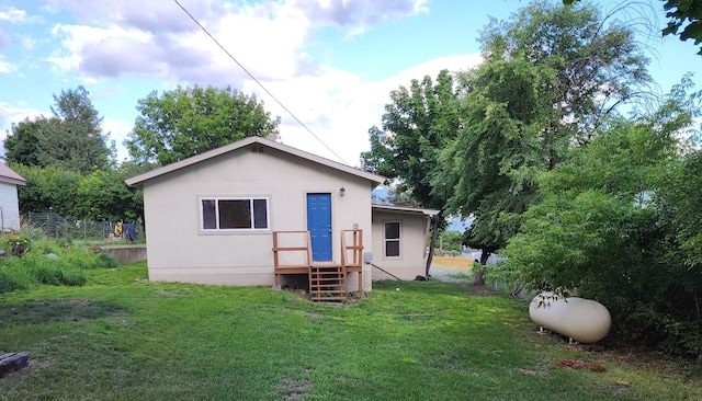 rear view of property with a lawn