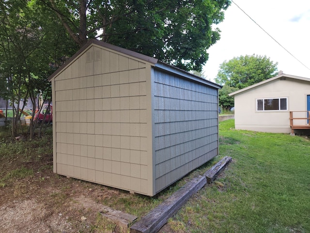 view of outbuilding with a lawn