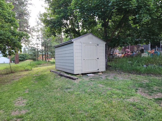 view of outbuilding with a yard