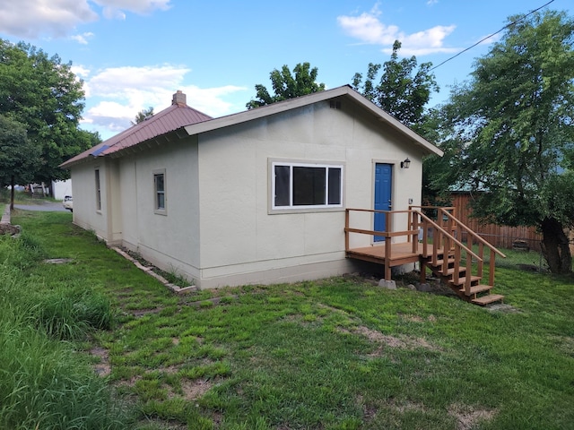 rear view of house with a yard