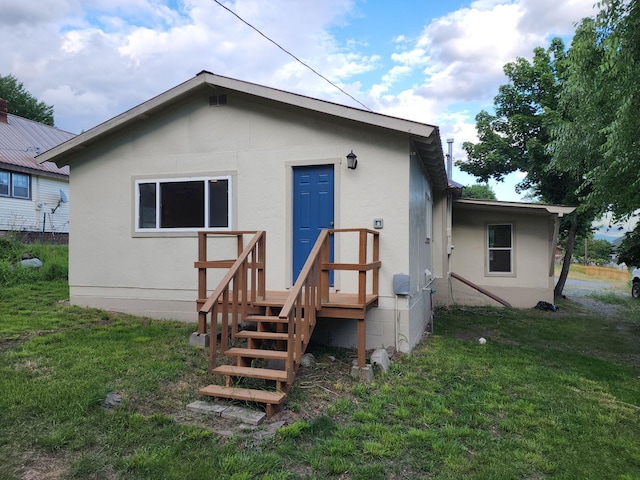 213 Washington St, Thompson Falls, MT 59873 - rear view of property with a lawn and stucco siding