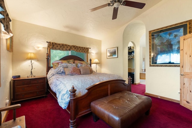 carpeted bedroom with multiple windows and ceiling fan