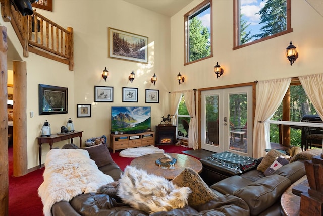 living room featuring a high ceiling and french doors