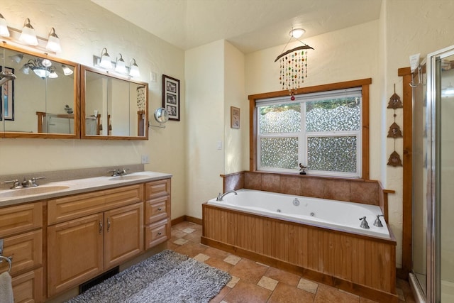 bathroom with a tub, vanity, and a chandelier