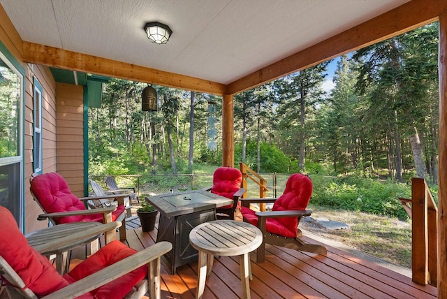 wooden terrace featuring an outdoor fire pit