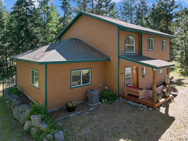 back of property featuring central AC unit and a deck