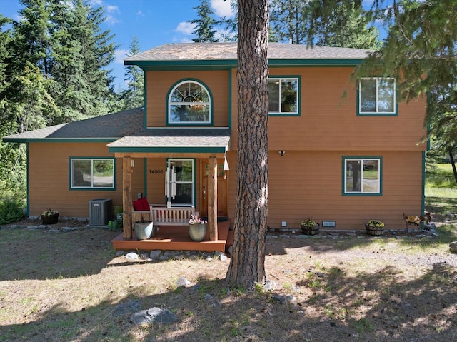 view of property featuring covered porch and central AC unit