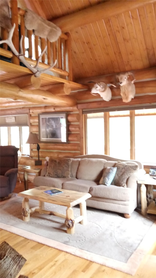 unfurnished living room with hardwood / wood-style flooring, lofted ceiling with beams, wood ceiling, and rustic walls