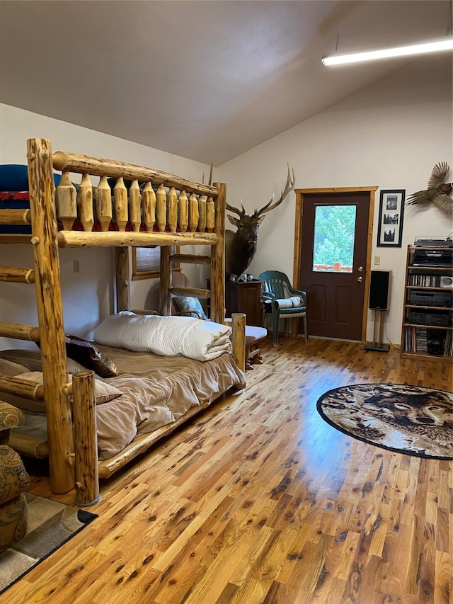 bedroom featuring hardwood / wood-style floors and vaulted ceiling