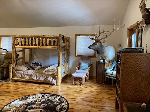 bedroom with lofted ceiling and hardwood / wood-style flooring