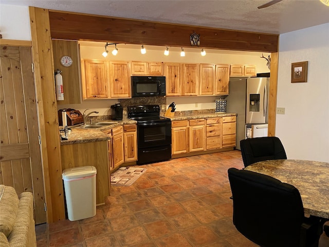 kitchen with ceiling fan, beamed ceiling, black appliances, dark tile patterned flooring, and sink