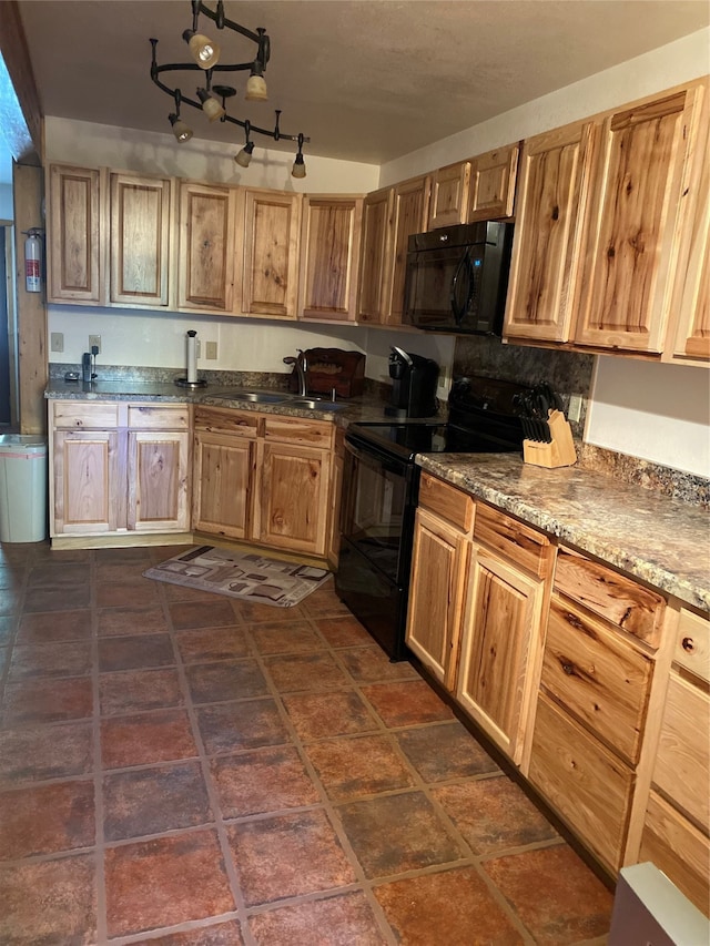 kitchen with dark tile patterned flooring, black appliances, sink, and an inviting chandelier