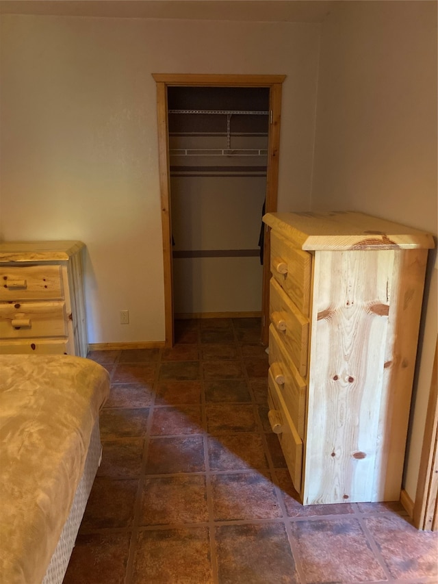 bedroom featuring a closet and dark tile patterned floors