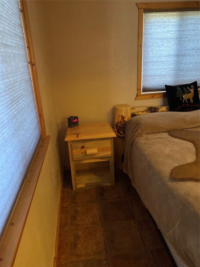 tiled bedroom with multiple windows