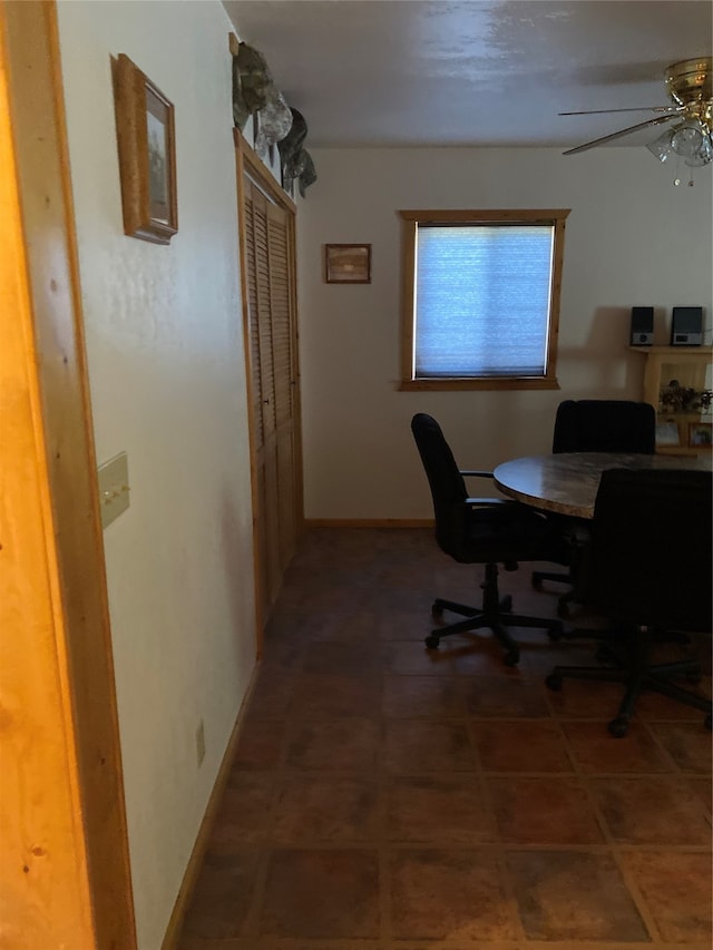 home office with tile patterned flooring and ceiling fan