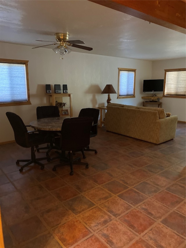 tiled dining room with a healthy amount of sunlight and ceiling fan