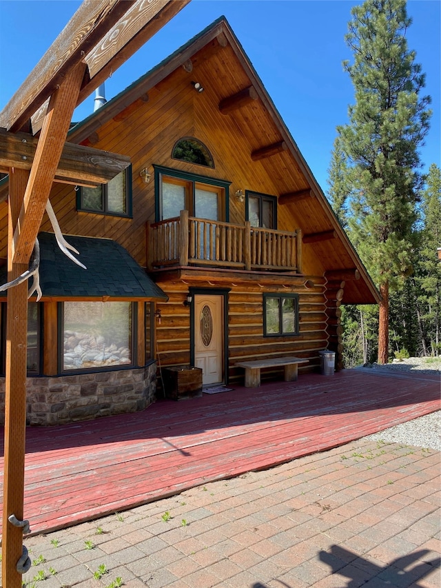 log-style house featuring a wooden deck