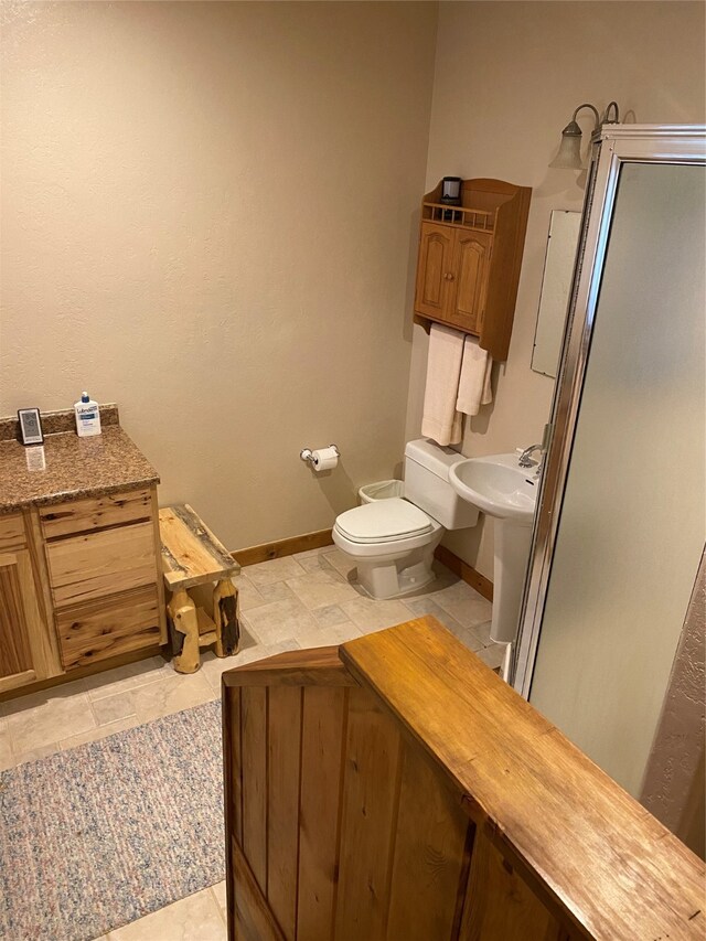 bathroom with a bidet, sink, toilet, and tile patterned floors