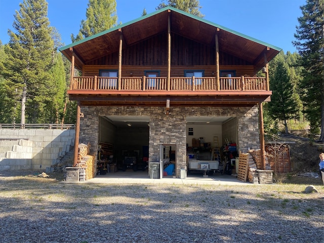 rear view of property with a balcony and a patio area