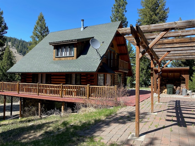 exterior space featuring a pergola, a patio area, and a wooden deck