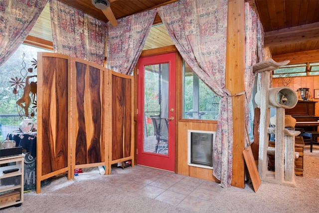 interior space featuring wood ceiling, tile patterned flooring, and a wealth of natural light