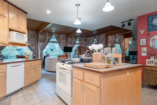 kitchen with white appliances, a kitchen island, hanging light fixtures, and light brown cabinets