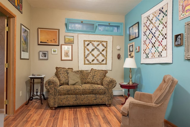 sitting room with hardwood / wood-style floors and baseboard heating