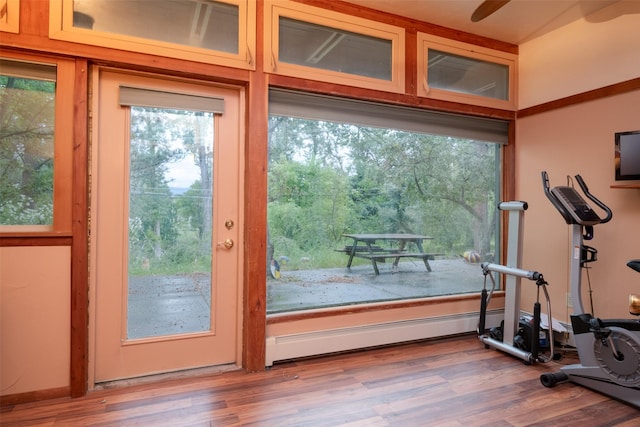 doorway with a baseboard radiator and hardwood / wood-style floors